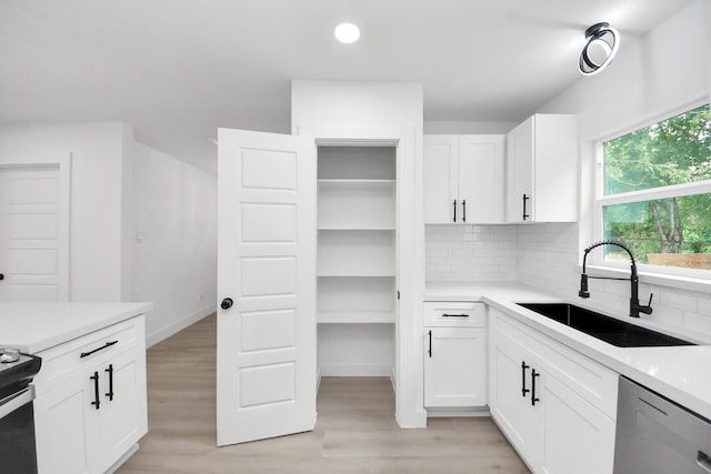 11503 Duane St, Houston, TX 77047 - kitchen with a sink, stainless steel appliances, light wood-style flooring, backsplash, and recessed lighting