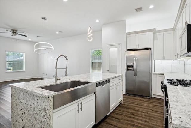 5041 Mallow St, Houston, TX 77033 - kitchen with stainless steel appliances, a sink, ceiling fan, dark wood-style floors, and recessed lighting