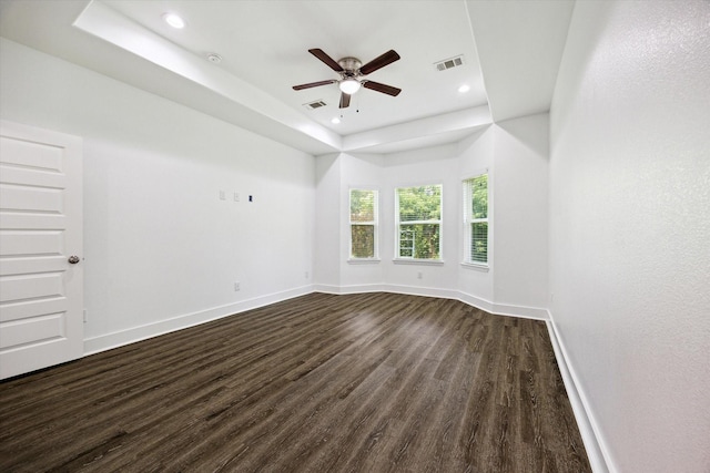 5041 Mallow St, Houston, TX 77033 - empty room with dark wood-style floors, a raised ceiling, baseboards, a ceiling fan, and recessed lighting