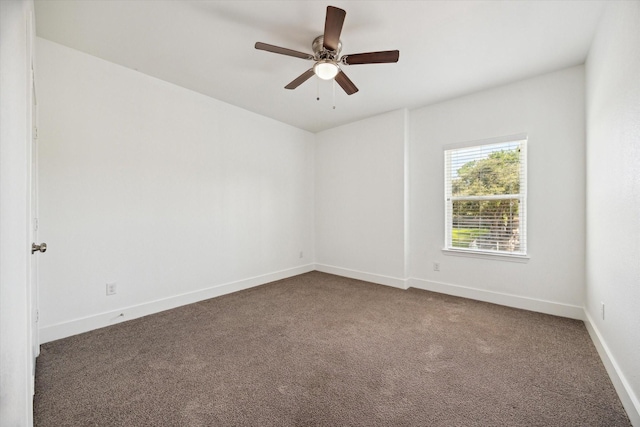 5041 Mallow St, Houston, TX 77033 - empty room featuring dark carpet, ceiling fan, and baseboards