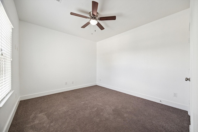 5041 Mallow St, Houston, TX 77033 - spare room with dark colored carpet, ceiling fan, and baseboards
