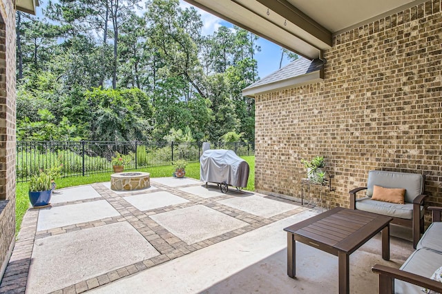 502 Pearl View Ln, Pinehurst, TX 77362 - fenced backyard featuring a grill, a patio, an outdoor fire pit, and view of wooded area