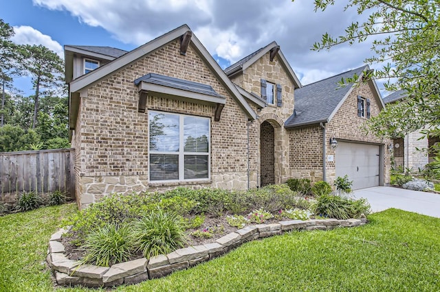 502 Pearl View Ln, Pinehurst, TX 77362 - view of front of home with stone siding, brick siding, concrete driveway, a shingled roof, and a garage