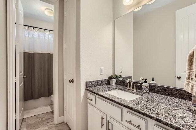 502 Pearl View Ln, Pinehurst, TX 77362 - bathroom featuring vanity, toilet, a shower with shower curtain, and marble look tile flooring