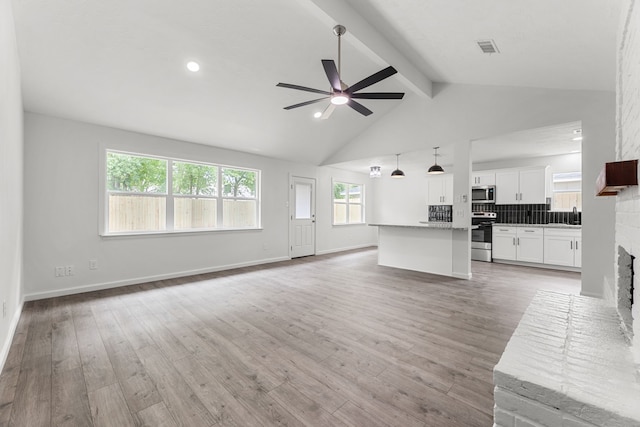 7414 Sunlight Ln, Houston, TX 77095 - unfurnished living room with a sink, a ceiling fan, light wood-type flooring, a brick fireplace, and recessed lighting