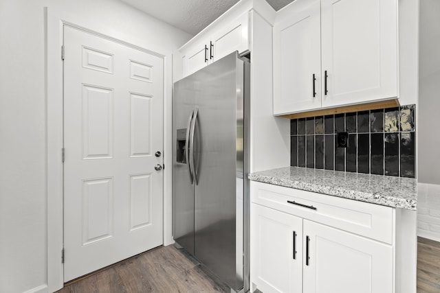 7414 Sunlight Ln, Houston, TX 77095 - kitchen featuring stainless steel fridge with ice dispenser, dark wood-type flooring, backsplash, and white cabinetry