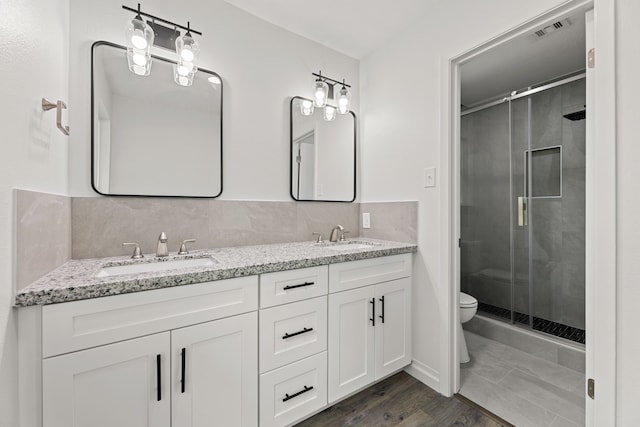 7414 Sunlight Ln, Houston, TX 77095 - bathroom with toilet, double vanity, a shower stall, and wood finished floors