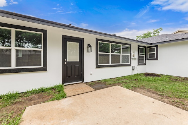 7414 Sunlight Ln, Houston, TX 77095 - view of exterior entry featuring stucco siding and a patio area