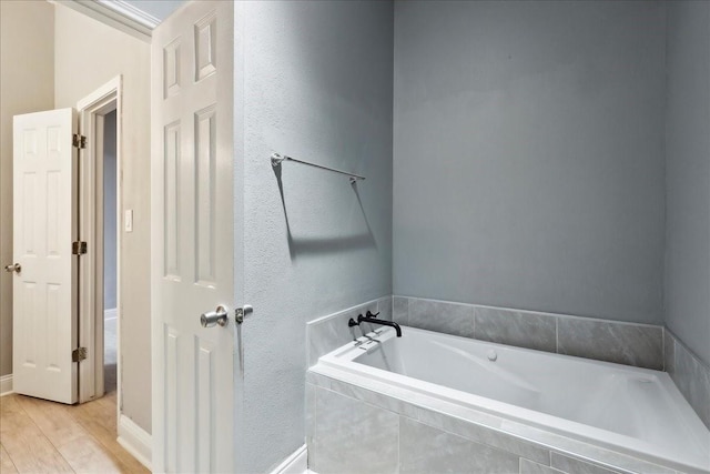 4138 Willow Bend Ln, Port Arthur, TX 77642 - bathroom with a bath, wood finished floors, and baseboards