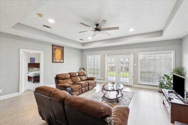 4138 Willow Bend Ln, Port Arthur, TX 77642 - living area with a tray ceiling, french doors, a ceiling fan, light wood finished floors, and recessed lighting