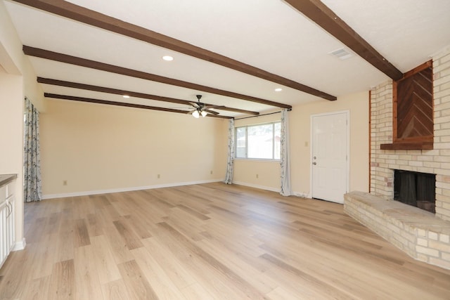 8606 Quail Vista Dr, Missouri City, TX 77489 - unfurnished living room featuring a brick fireplace, ceiling fan, beam ceiling, light wood-style floors, and baseboards