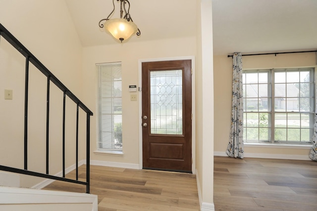 8606 Quail Vista Dr, Missouri City, TX 77489 - entrance foyer with light wood-style flooring, baseboards, and stairway
