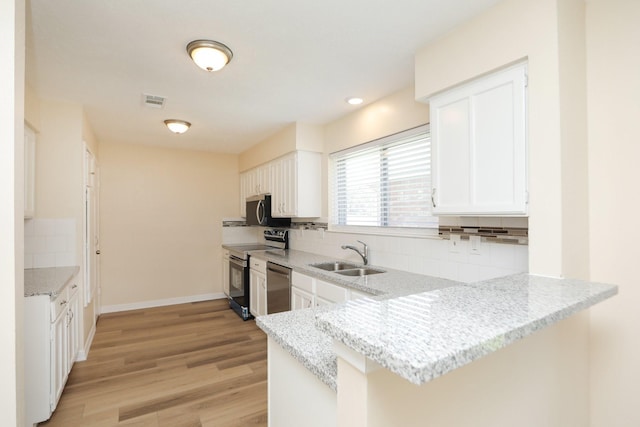 8606 Quail Vista Dr, Missouri City, TX 77489 - kitchen featuring a sink, appliances with stainless steel finishes, decorative backsplash, white cabinets, and recessed lighting