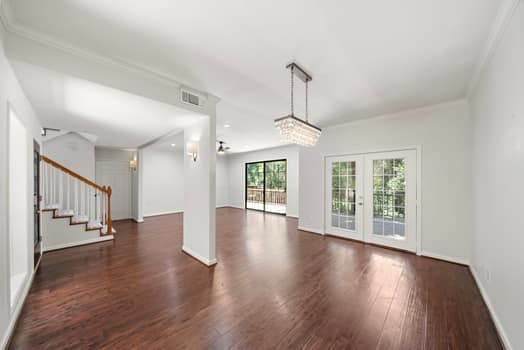 201 Vanderpool Ln Unit 118, Houston, TX 77024 - unfurnished living room featuring wood finished floors, french doors, stairs, and baseboards