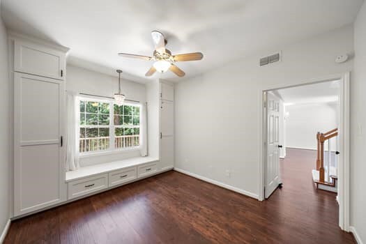201 Vanderpool Ln Unit 118, Houston, TX 77024 - spare room featuring dark wood-style floors, ceiling fan, and baseboards