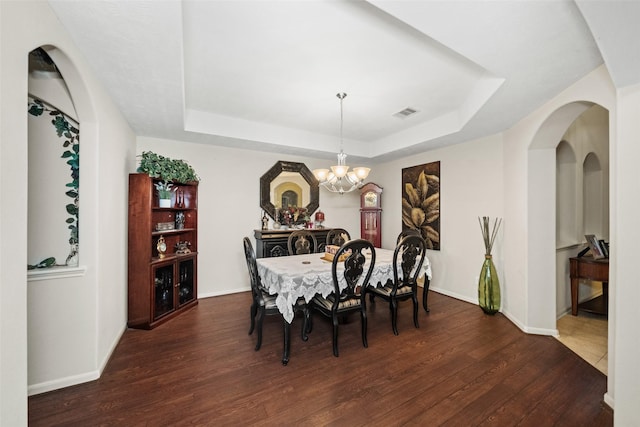17335 Lake Clark Ln, Humble, TX 77346 - dining area featuring a tray ceiling, wood finished floors, and a chandelier