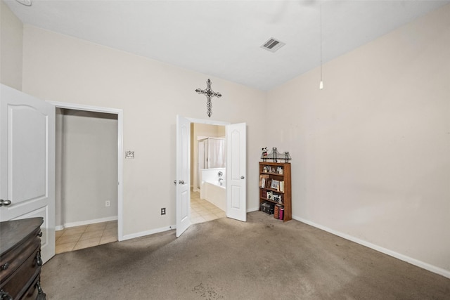 17335 Lake Clark Ln, Humble, TX 77346 - carpeted bedroom featuring baseboards and connected bathroom