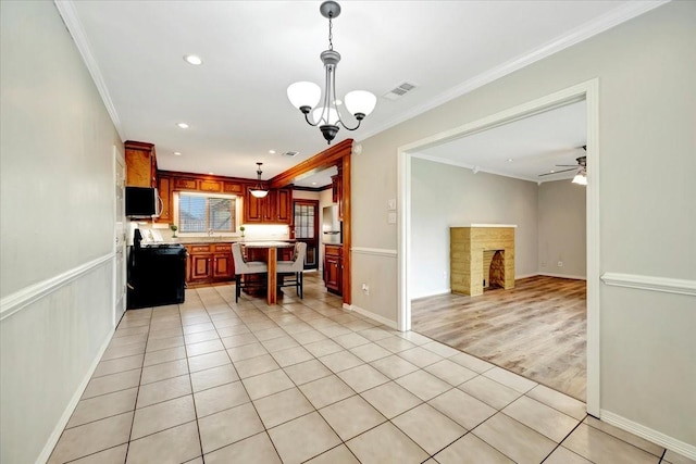 515 Canadian St, Houston, TX 77009 - kitchen with ornamental molding, light countertops, recessed lighting, open floor plan, and light tile patterned floors