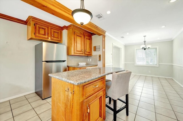 515 Canadian St, Houston, TX 77009 - kitchen featuring freestanding refrigerator, light tile patterned floors, backsplash, crown molding, and hanging light fixtures