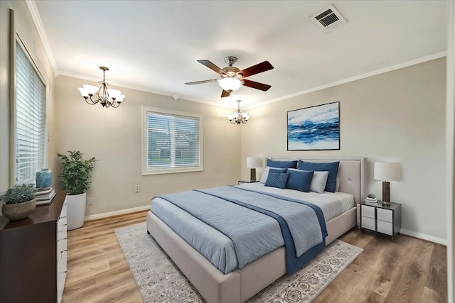 515 Canadian St, Houston, TX 77009 - bedroom featuring a chandelier, ornamental molding, light wood-type flooring, baseboards, and a ceiling fan