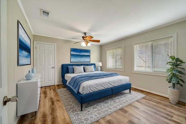 515 Canadian St, Houston, TX 77009 - bedroom featuring ornamental molding, light wood-style floors, baseboards, and a ceiling fan
