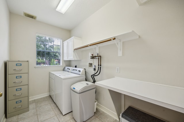 5539 Emerald Pointe Ct, Sugar Land, TX 77479 - washroom with cabinet space, washing machine and clothes dryer, baseboards, and light tile patterned flooring