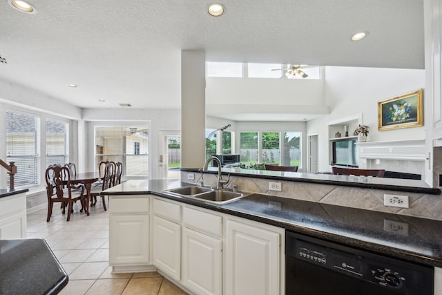 5539 Emerald Pointe Ct, Sugar Land, TX 77479 - kitchen with dishwasher, a sink, dark countertops, light tile patterned floors, and white cabinets