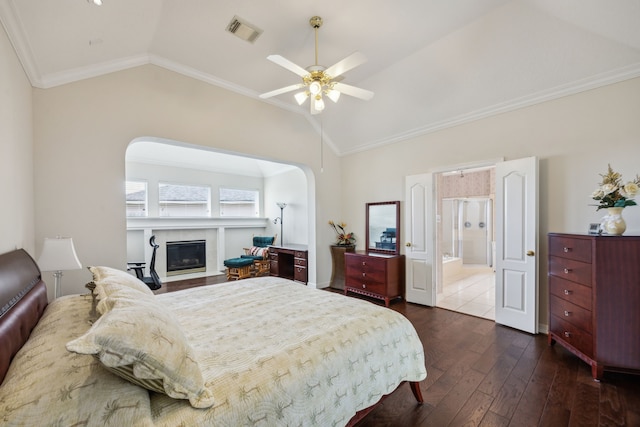 5539 Emerald Pointe Ct, Sugar Land, TX 77479 - bedroom with lofted ceiling, dark wood finished floors, crown molding, a glass covered fireplace, and ensuite bath