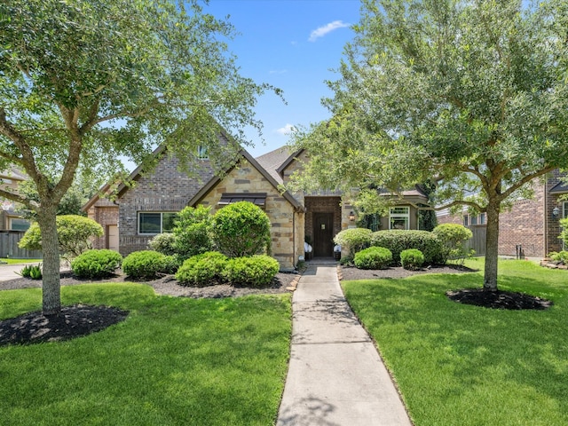 17611 Bear River Ln, Humble, TX 77346 - view of front of home with a front yard, brick siding, and stone siding