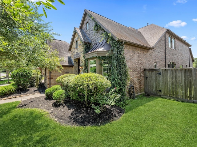 17611 Bear River Ln, Humble, TX 77346 - view of property exterior featuring a shingled roof, stone siding, and brick siding