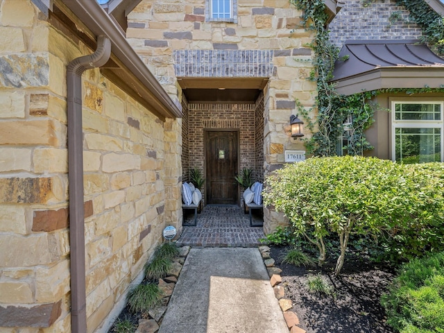 17611 Bear River Ln, Humble, TX 77346 - entrance to property featuring stone siding, a standing seam roof, brick siding, and metal roof