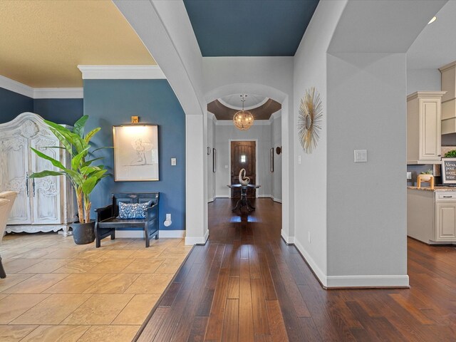 17611 Bear River Ln, Humble, TX 77346 - entryway with arched walkways, baseboards, hardwood / wood-style floors, and crown molding