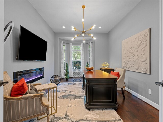 17611 Bear River Ln, Humble, TX 77346 - dining area with a chandelier, baseboards, wood finished floors, recessed lighting, and a glass covered fireplace