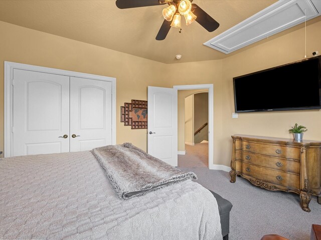 17611 Bear River Ln, Humble, TX 77346 - carpeted bedroom featuring attic access, a closet, baseboards, a ceiling fan, and arched walkways