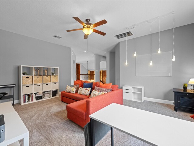 17611 Bear River Ln, Humble, TX 77346 - living area featuring carpet floors, ceiling fan, arched walkways, and baseboards