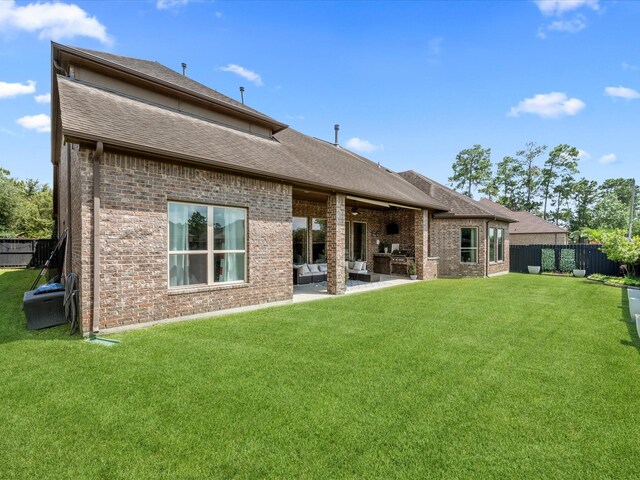 17611 Bear River Ln, Humble, TX 77346 - back of property featuring brick siding, an outdoor living space, a patio area, and a shingled roof
