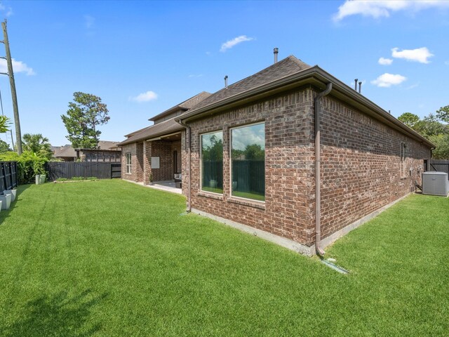 17611 Bear River Ln, Humble, TX 77346 - back of property with central air condition unit and brick siding