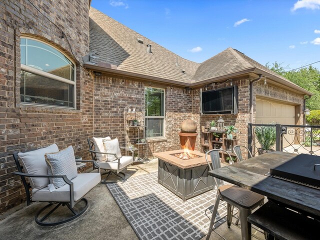 17611 Bear River Ln, Humble, TX 77346 - view of patio / terrace with a garage and an outdoor fire pit