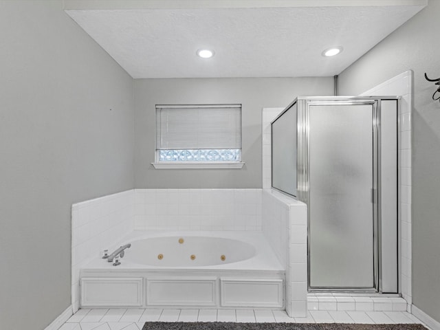 3106 Lake Breeze Ln, Crosby, TX 77532 - full bathroom with a stall shower, a jetted tub, baseboards, tile patterned flooring, and a textured ceiling