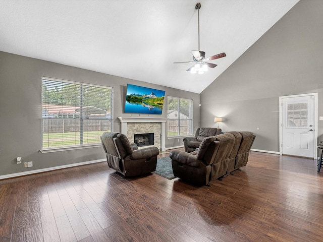 3106 Lake Breeze Ln, Crosby, TX 77532 - living area with ceiling fan, dark wood finished floors, baseboards, a stone fireplace, and high vaulted ceiling