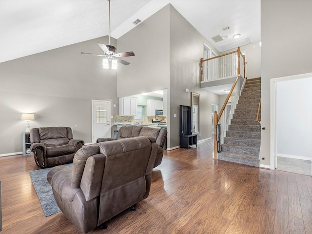 3106 Lake Breeze Ln, Crosby, TX 77532 - living area with high vaulted ceiling, a ceiling fan, wood finished floors, baseboards, and stairs