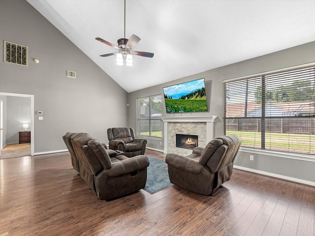 3106 Lake Breeze Ln, Crosby, TX 77532 - living room with high vaulted ceiling, a ceiling fan, a stone fireplace, baseboards, and wood finished floors