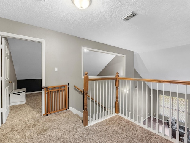3106 Lake Breeze Ln, Crosby, TX 77532 - hall with carpet flooring, vaulted ceiling, an upstairs landing, a textured ceiling, and baseboards