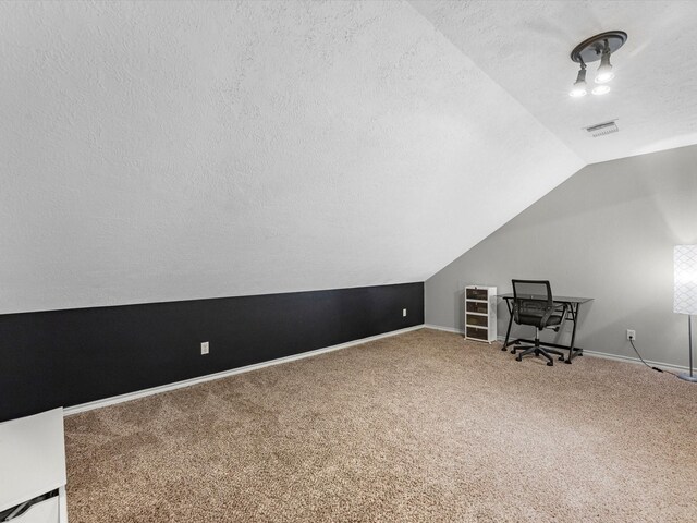 3106 Lake Breeze Ln, Crosby, TX 77532 - bonus room with a textured ceiling, carpet, lofted ceiling, and baseboards