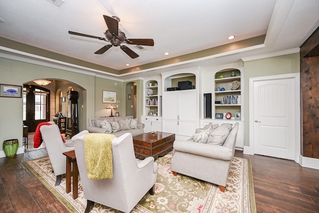 23442 Hillcrest Dr, Hockley, TX 77447 - living room featuring arched walkways, ceiling fan, dark wood-style floors, baseboards, and crown molding