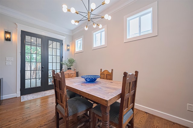 804 Enid St Unit A, Houston, TX 77009 - dining area featuring a chandelier, plenty of natural light, light wood finished floors, ornamental molding, and french doors