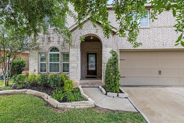 21734 Parsley Mist Ln, Richmond, TX 77469 - view of front facade featuring concrete driveway, a garage, brick siding, and stone siding