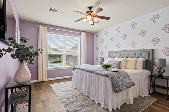 21734 Parsley Mist Ln, Richmond, TX 77469 - bedroom featuring wood finished floors, baseboards, wallpapered walls, and ceiling fan