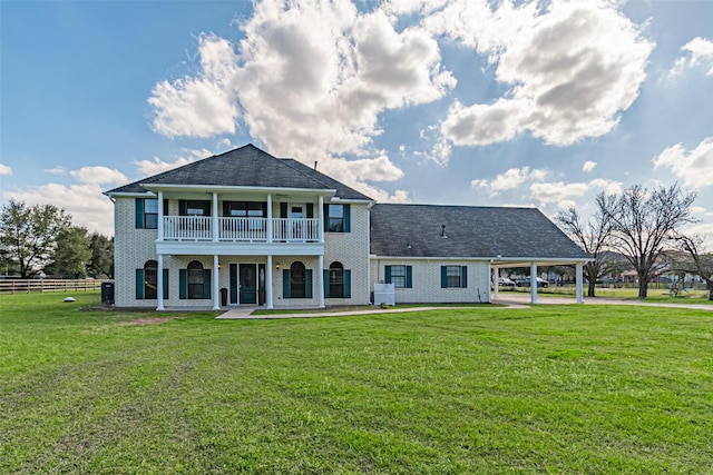 17631 Huffmeister Rd, Cypress, TX 77429 - back of house featuring a balcony, an attached carport, and brick siding