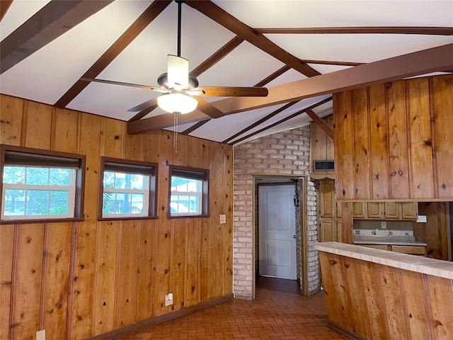 10214 Moorberry Ln, Houston, TX 77043 - kitchen featuring wood walls, light countertops, a ceiling fan, and brick floors
